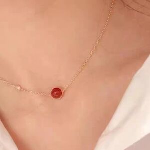 Delicate Gold Necklace with Red Gemstone Pendant